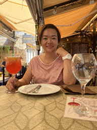 Miaomiao with a cocktail at the terrace of the Regina Del Gusto restaurant