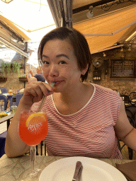 Miaomiao with a cocktail at the terrace of the Regina Del Gusto restaurant