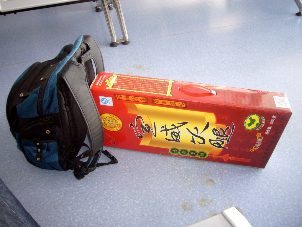 Backpack and box with pig leg, at Kunming Wujiaba International Airport