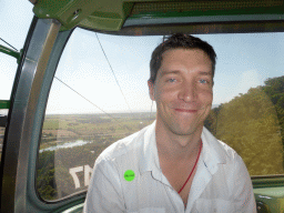 Tim in a Skyrail Rainforest Cableway gondola, with a view on the Smithfield Skyrail Terminal and surroundings