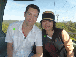 Tim and Miaomiao in a Skyrail Rainforest Cableway gondola, with a view on the tropical rainforest southeast of Barron Falls Skyrail Station