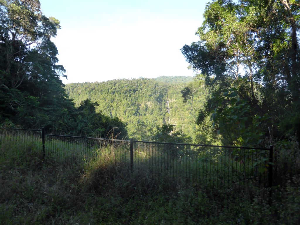 Hills with trees on the other side of the Barron Creek valley, viewed from the Kuranda Scenic Railway train at the Forwards Lookout