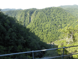 Hills with trees on the other side of the Barron Creek valley, viewed from the Kuranda Scenic Railway train near the Forwards Lookout