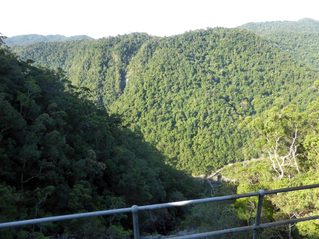 Hills with trees on the other side of the Barron Creek valley, viewed from the Kuranda Scenic Railway train near the Forwards Lookout