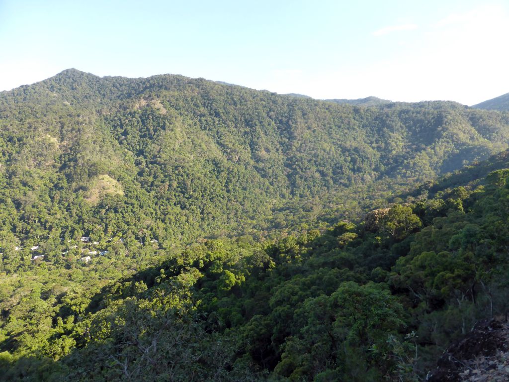 Hills with trees on the other side of the Barron Creek valley, viewed from the Kuranda Scenic Railway train near the Red Bluff rocks