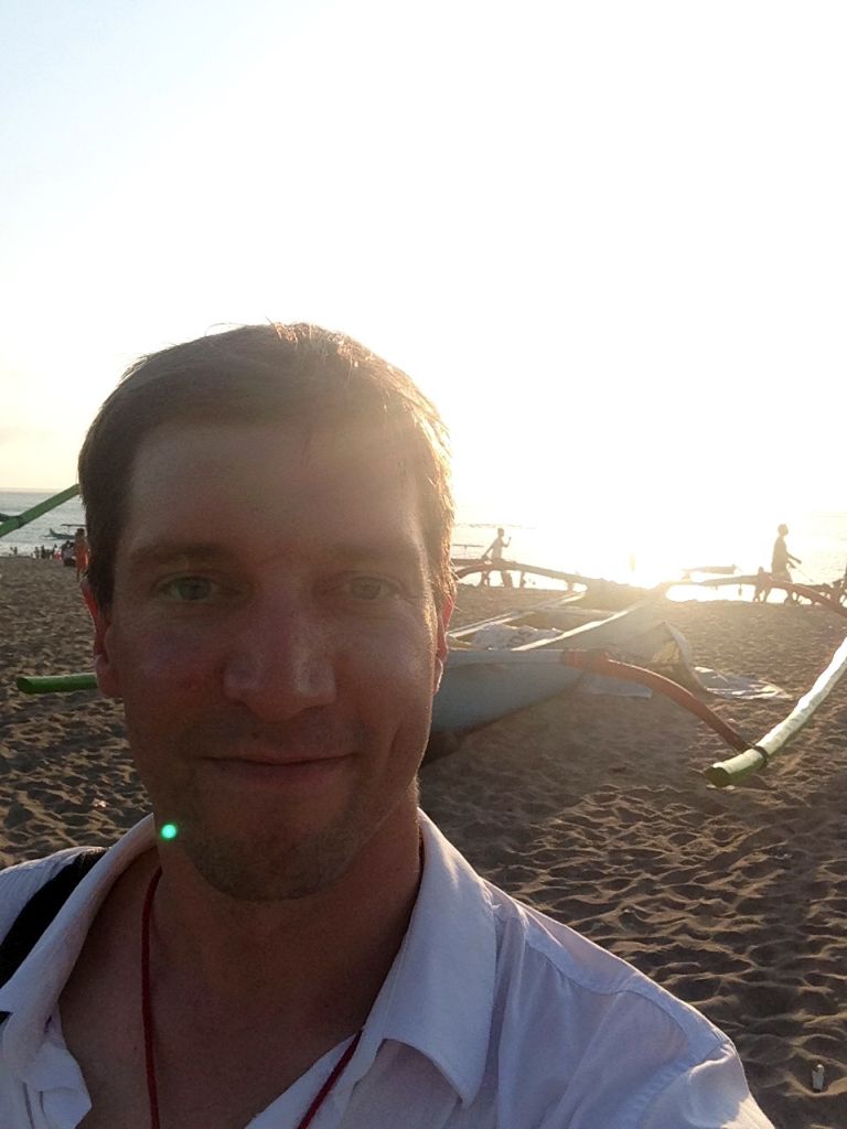 Tim with boats at the Pantai Jerman beach