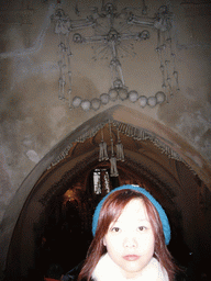 Miaomiao and a wall with skulls and bones in the Sedlec Ossuary