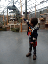 Max with a Tyrannosaurus Rex statue at the Dino Expo at the Berkenhof Tropical Zoo