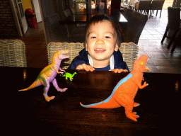 Max with dinosaur toys at the restaurant of the Berkenhof Tropical Zoo