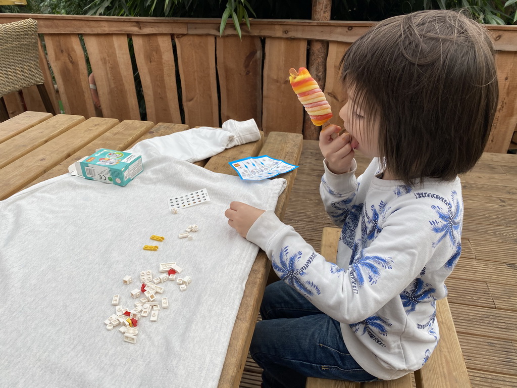 Max playing with a toy and eating an ice cream at the Kids Jungle at the Berkenhof Tropical Zoo