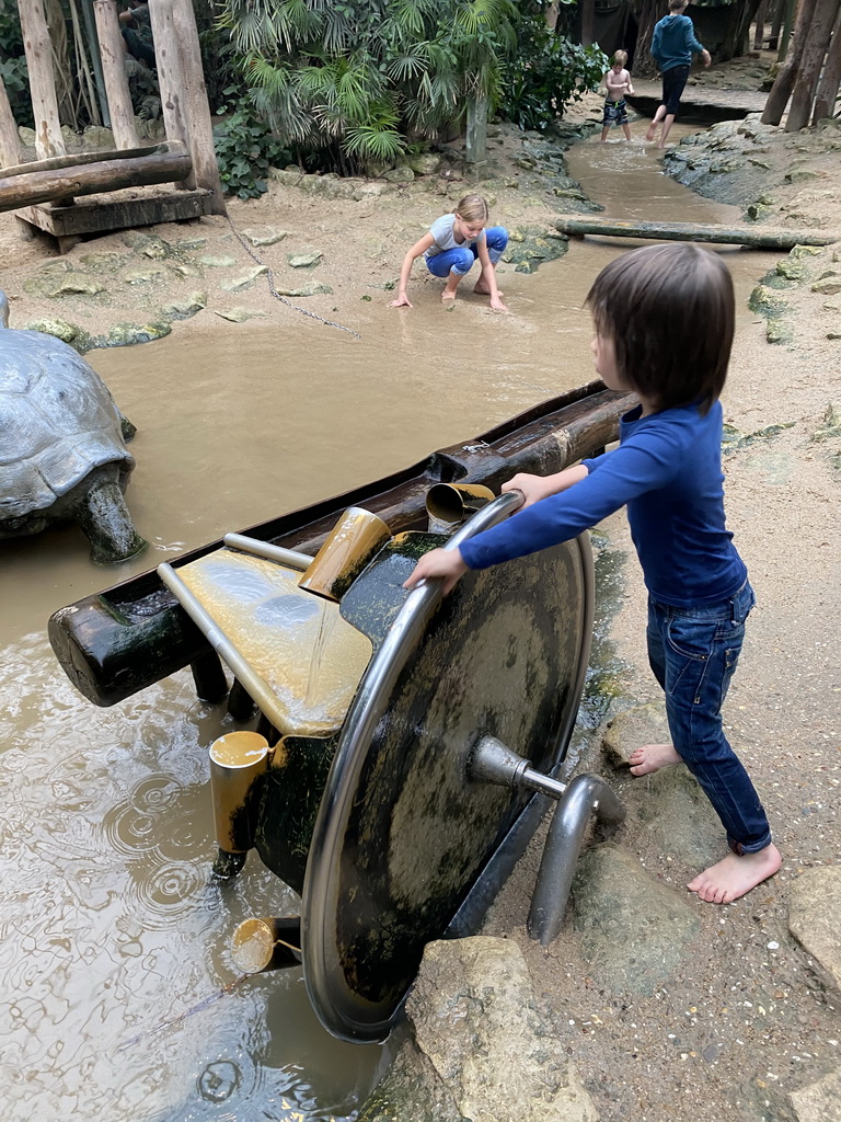 Max playing with a water wheel at the Kids Jungle at the Berkenhof Tropical Zoo