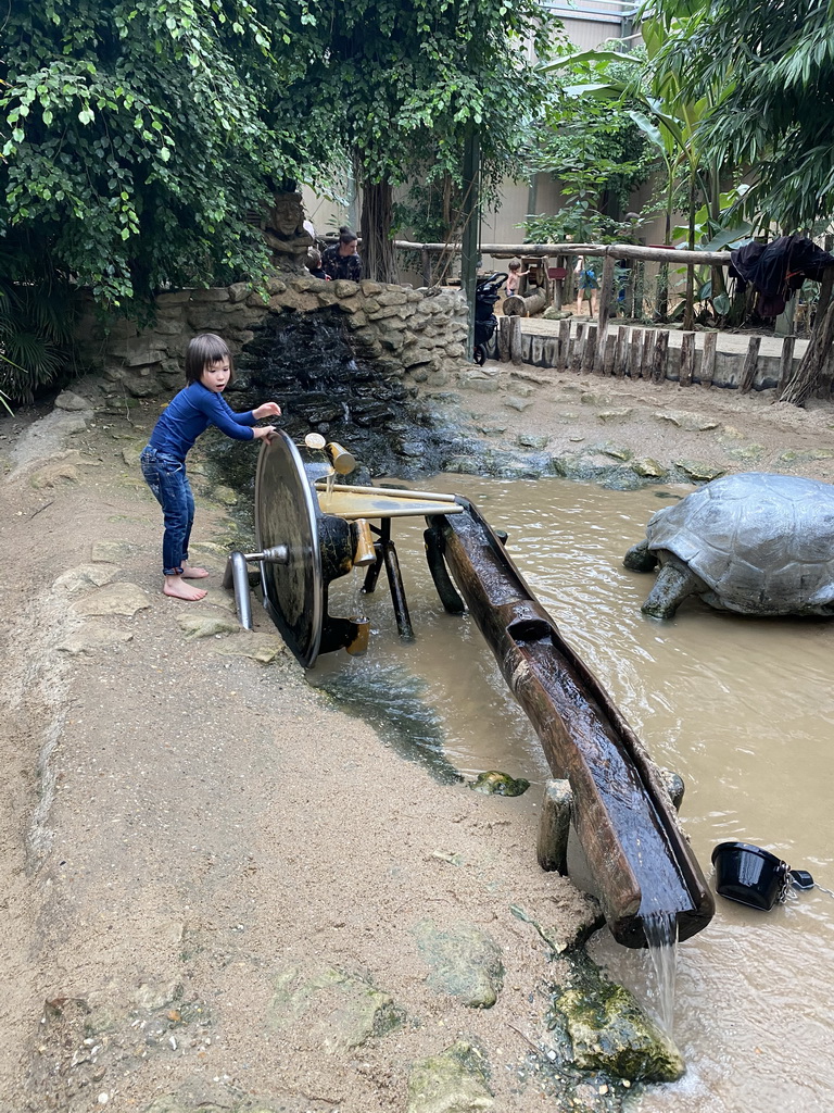 Max playing with a water wheel at the Kids Jungle at the Berkenhof Tropical Zoo