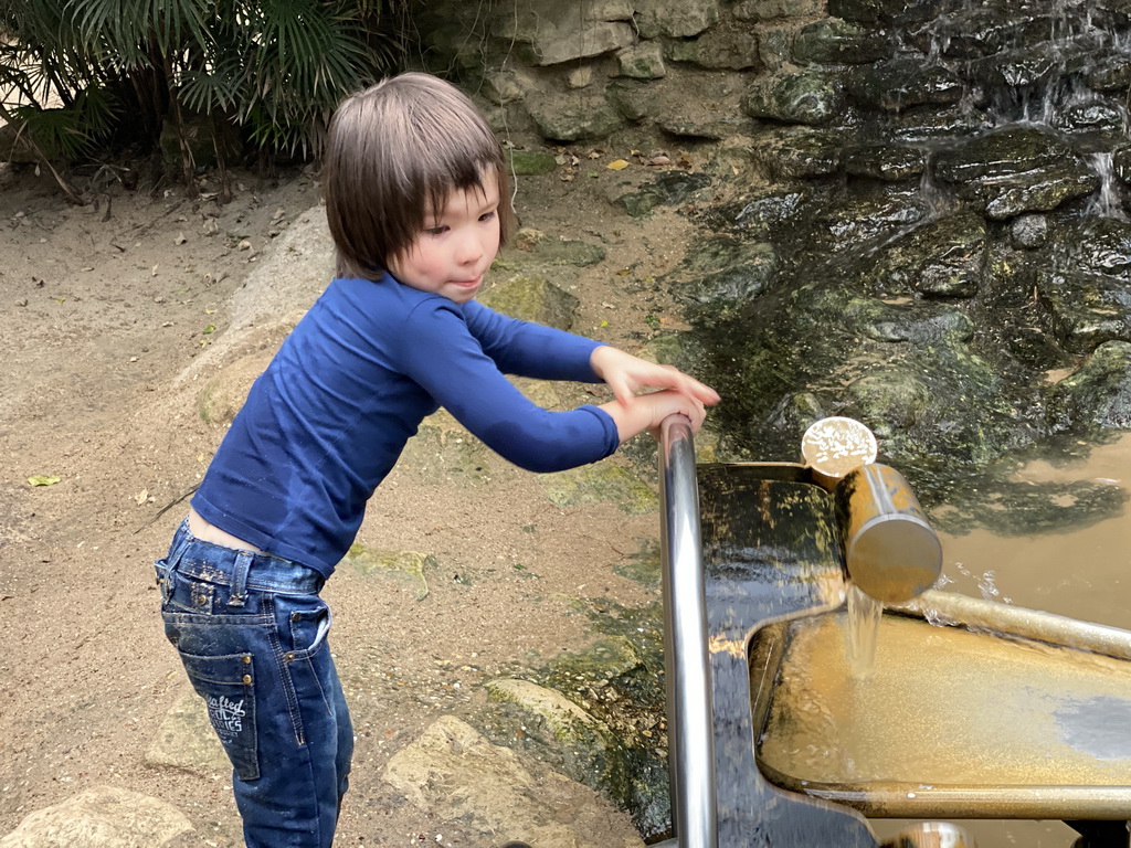 Max playing with a water wheel at the Kids Jungle at the Berkenhof Tropical Zoo