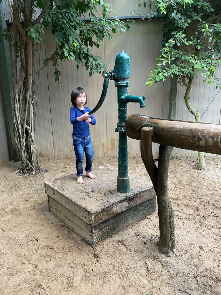 Max playing with a water pump at the Kids Jungle at the Berkenhof Tropical Zoo