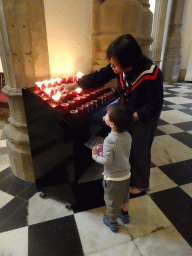 Miaomiao and Max lighting candles at the La Laguna Cathedral