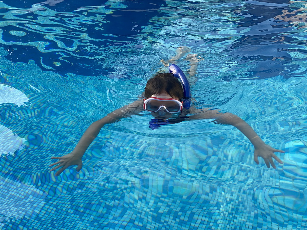 Max with goggles and snorkel at the outdoor swimming pool of the Grand Hotel Park