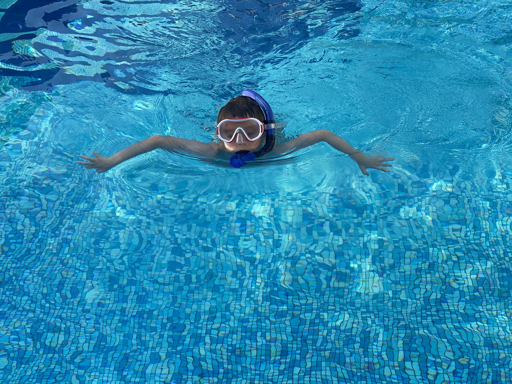 Max with goggles and snorkel at the outdoor swimming pool of the Grand Hotel Park