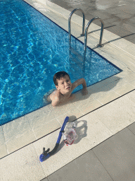 Max with goggles and snorkel at the outdoor swimming pool of the Grand Hotel Park