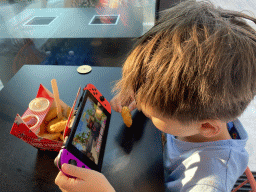 Max having dinner and watching a movie on his Nintendo Switch at the Pizzeria Tuttobene restaurant