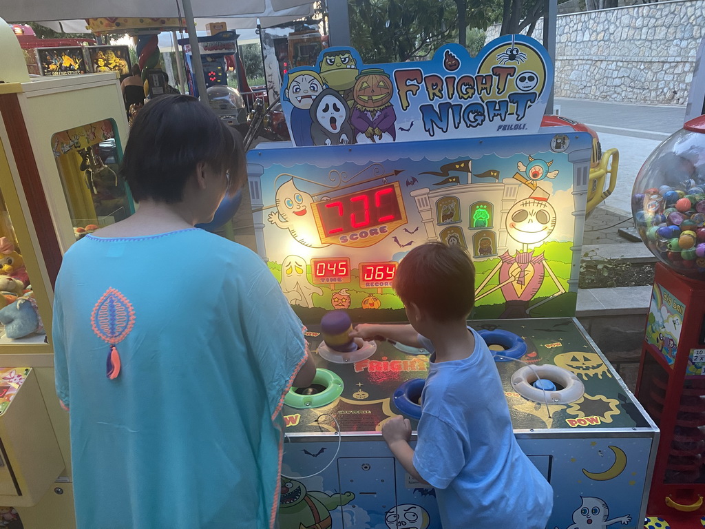 Miaomiao and Max playing the `Fright Night` hammer game at the crossing of the etalite Kralja Zvonimira and Masarykov Put streets, at sunset