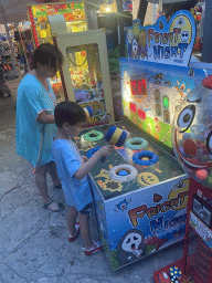 Miaomiao and Max playing the `Fright Night` hammer game at the crossing of the etalite Kralja Zvonimira and Masarykov Put streets, at sunset