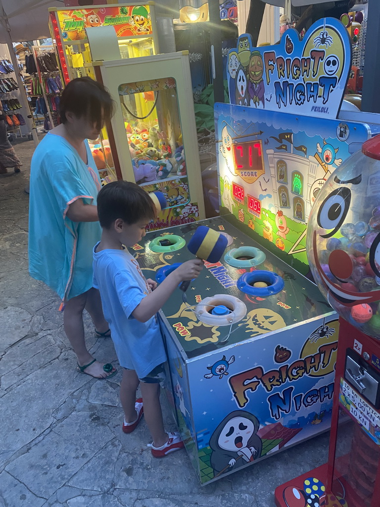 Miaomiao and Max playing the `Fright Night` hammer game at the crossing of the etalite Kralja Zvonimira and Masarykov Put streets, at sunset