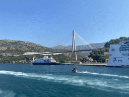 The cruise ships `SeaDream Yacht Club` and `Norwegian Gem` at the Gru Port and the Franjo Tudman Bridge over the Rijeka Dubrovacka inlet, viewed from the Elaphiti Islands tour boat