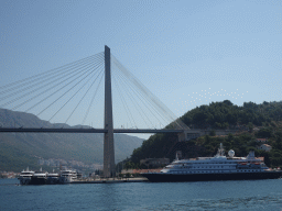 The cruise ship `SeaDream Yacht Club` and other boats at the Gru Port and the Franjo Tudman Bridge over the Rijeka Dubrovacka inlet, viewed from the Elaphiti Islands tour boat