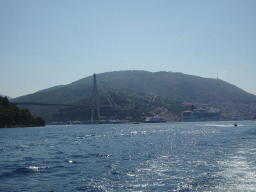 The cruise ships `SeaDream Yacht Club`, `Norwegian Gem` and `Jadrolinija Dubrovnik` and other boats at the Gru Port and the Franjo Tudman Bridge over the Rijeka Dubrovacka inlet, viewed from the Elaphiti Islands tour boat