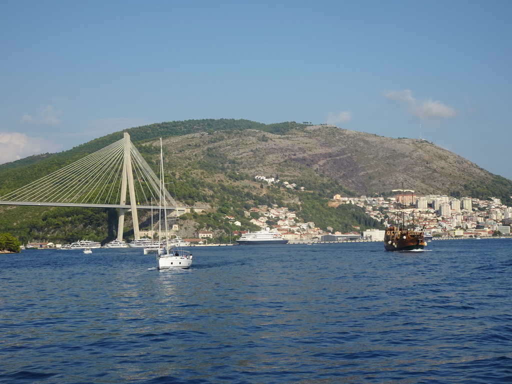 Boats and old ship leaving the Gru Port and the Franjo Tudman Bridge over the Rijeka Dubrovacka inlet, viewed from the Elaphiti Islands tour boat