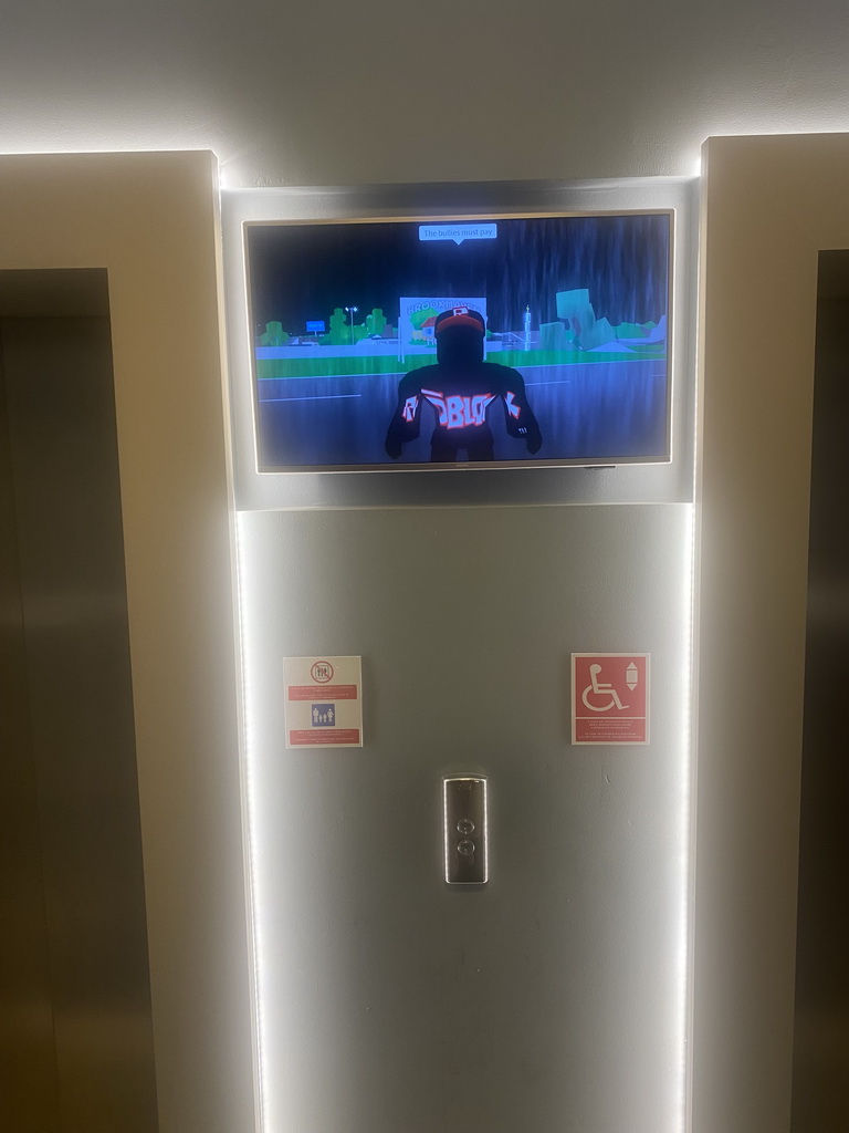 Roblox movie on a screen in front of the elevators at the Grand Hotel Park