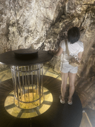Miaomiao with the table and glass floor at the small cave at the Cave Bar More