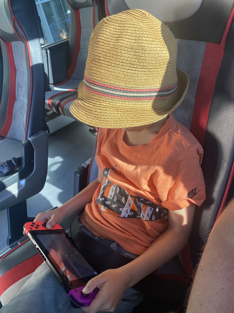 Max playing on his Nintendo Switch at the bus to Perast