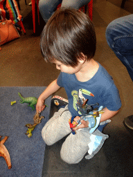 Max playing with dinosaur toys at the Workshop at the Fifth Floor of the Naturalis Biodiversity Center