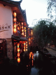 Houses and canal in the Old City of Lijiang, at sunset