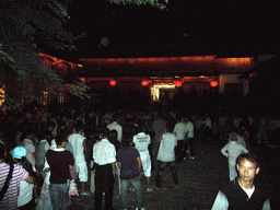 People dancing in the streets of the Old City of Lijiang, by night