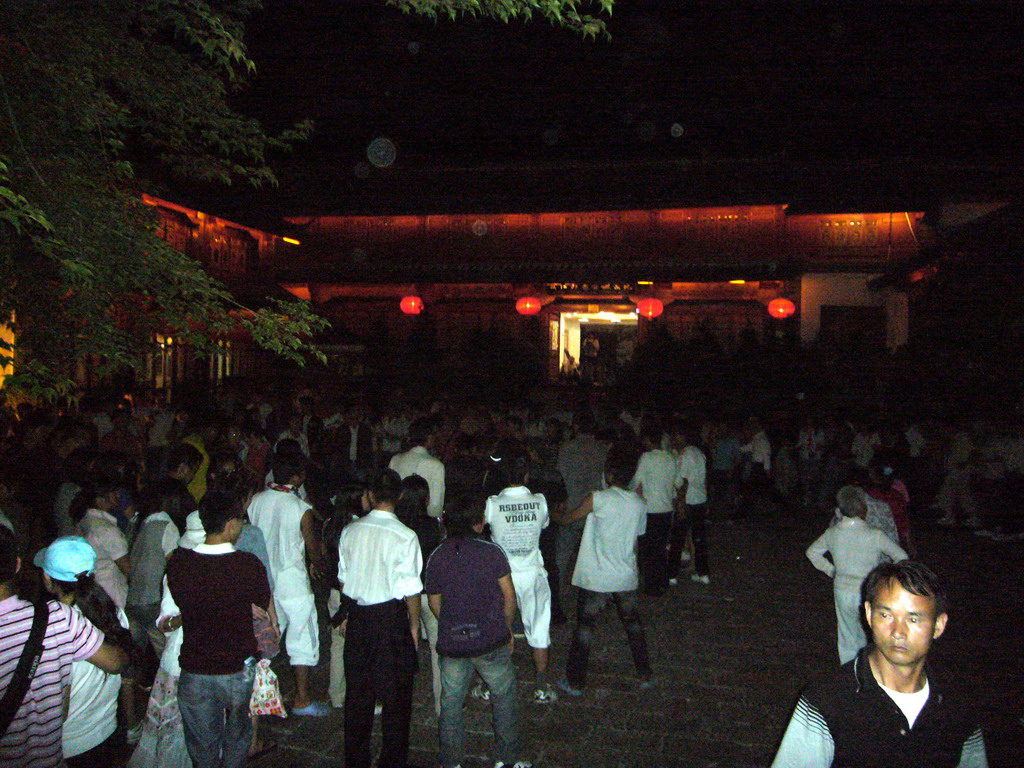 People dancing in the streets of the Old City of Lijiang, by night