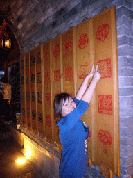 Miaomiao with characters in the Naxi language, in the Old City of Lijiang