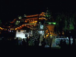 Water wheel and Qian Xue Lou Hotel at Yuhe Square in the Old City of Lijiang, by night