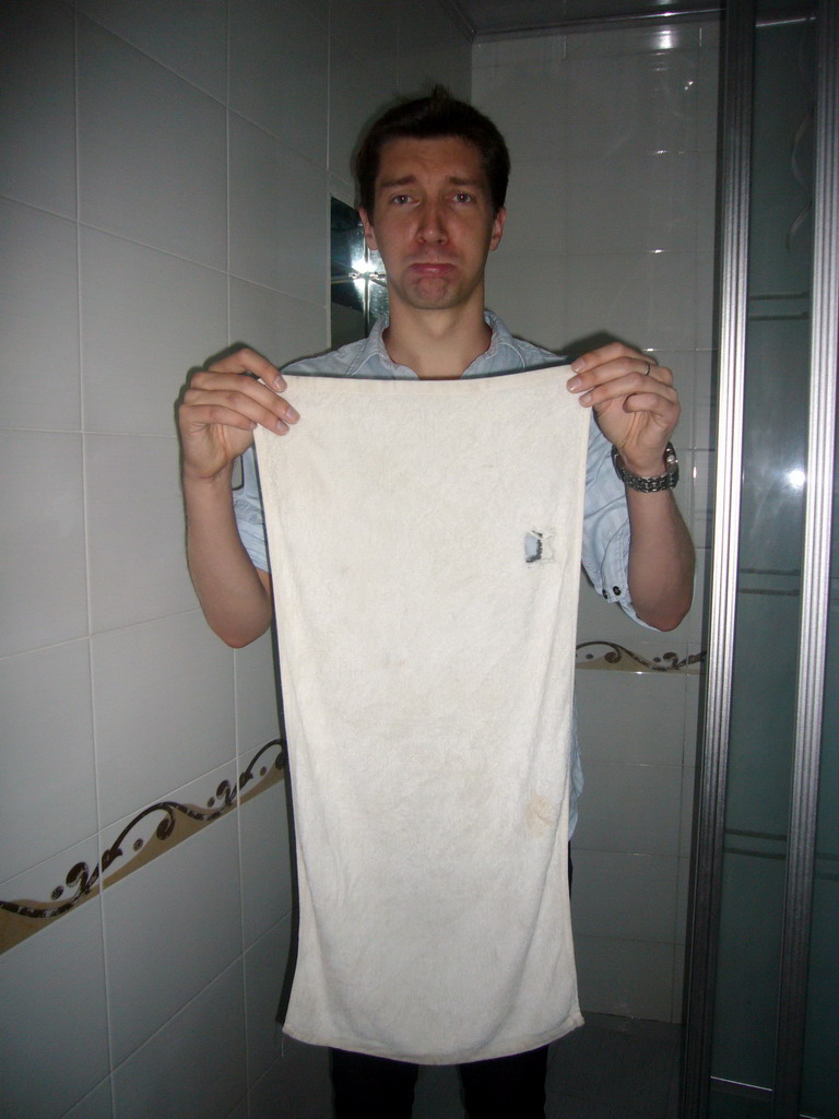 Tim with a towel in our bathroom in the Sunny 100 Business Hotel