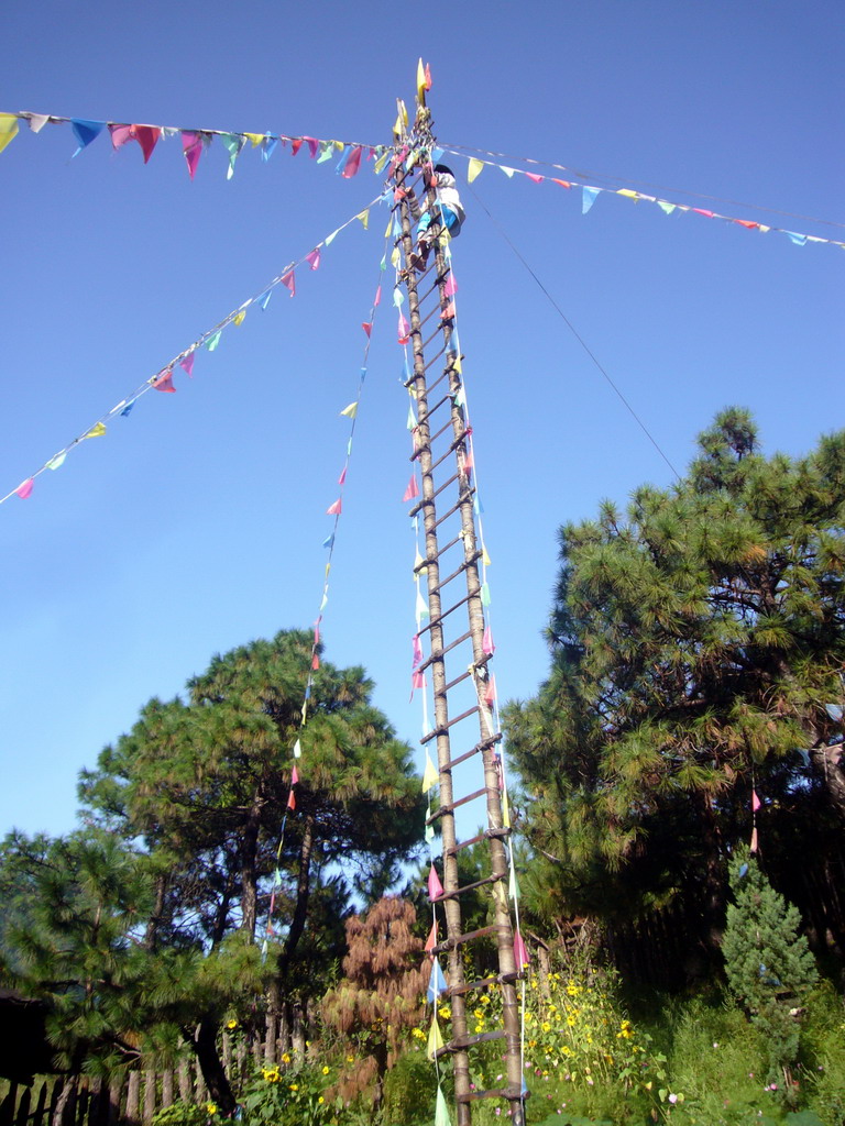 Man on stairs made of swords, in a Minority Village near Lijiang