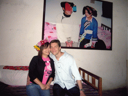 Tim and Miaomiao in the bedroom of a minority house, in a Minority Village near Lijiang