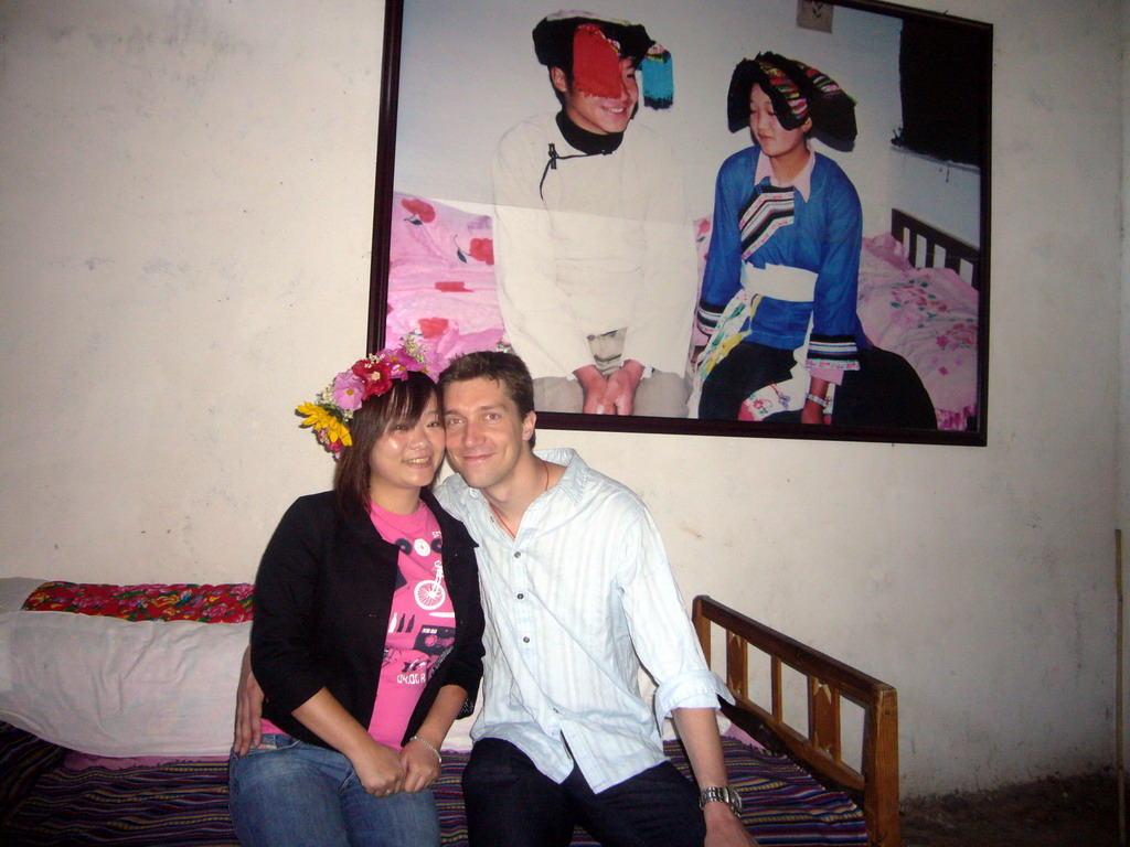 Tim and Miaomiao in the bedroom of a minority house, in a Minority Village near Lijiang