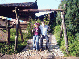 Tim and Miaomiao on a swing, in a Minority Village near Lijiang