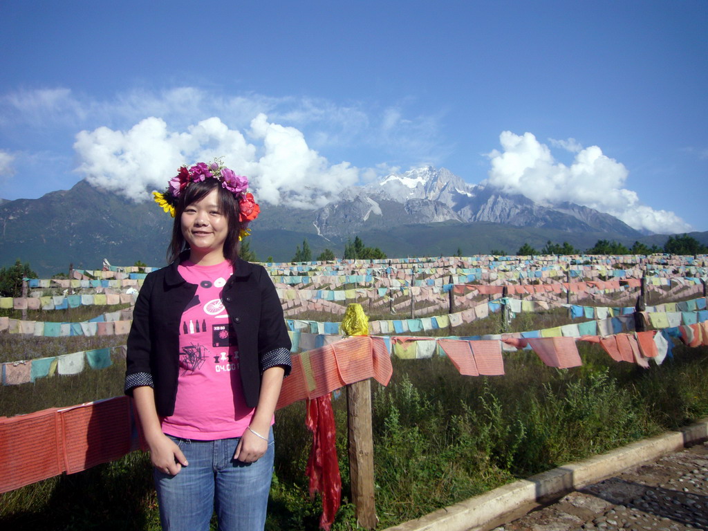 Miaomiao and prayer flags in a Minority Village near Lijiang, with view on Jade Dragon Snow Mountain