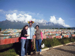 Tim, Miaomiao, Miaomiao`s mother and prayer flags in a Minority Village near Lijiang, with view on Jade Dragon Snow Mountain
