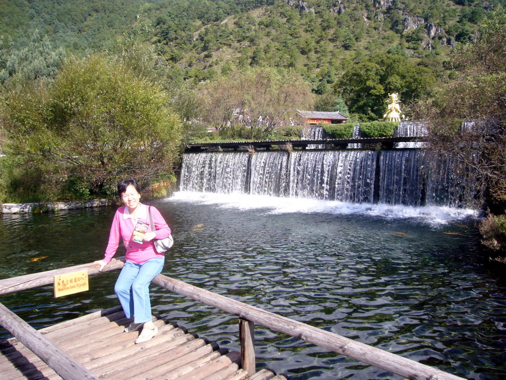 Miaomiao`s mother at the Three-Tier Waterfall and Divine Spring at Jade Water Village