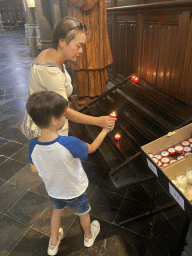 Miaomiao and Max lighting a candle at the Lille Cathedral