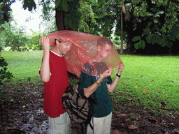 Tim and his friend under a rain coat at the Limbe Botanic Garden