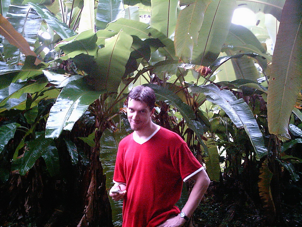 Tim with a plant at the Limbe Botanic Garden